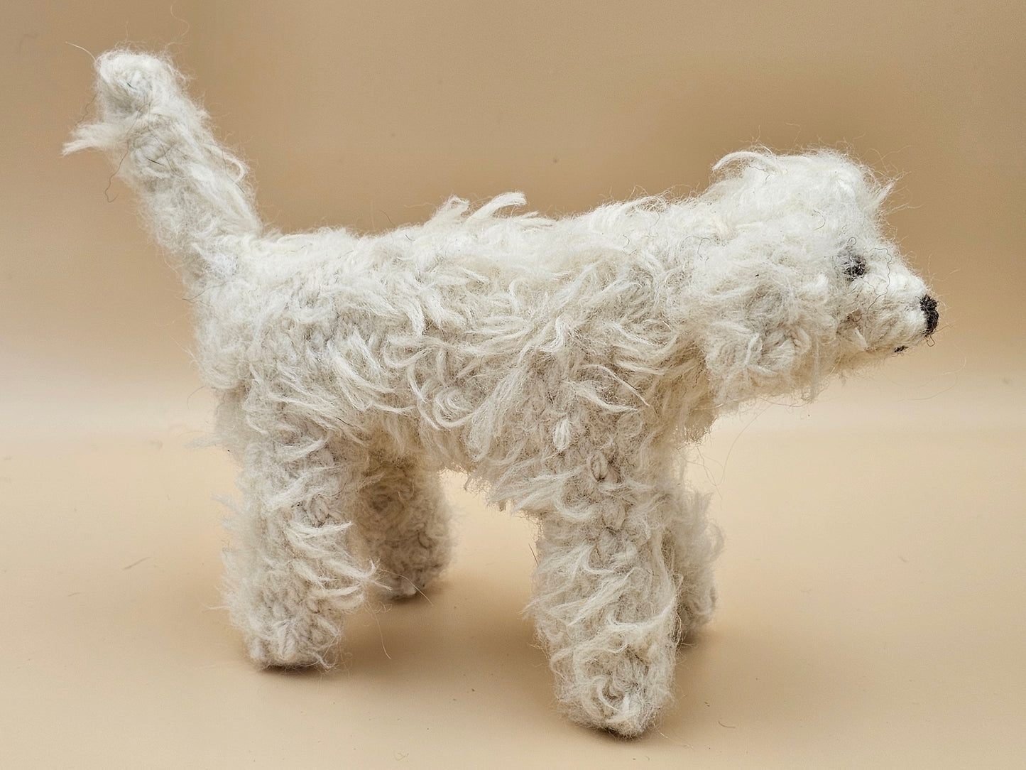 Fluffy handknitted hairy off white Labradoodle with movable head, legs and tail.