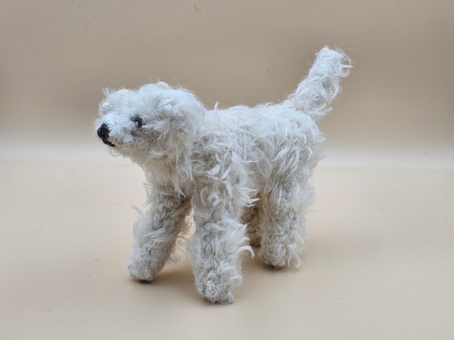 Fluffy handknitted hairy off white Labradoodle with movable head, legs and tail.